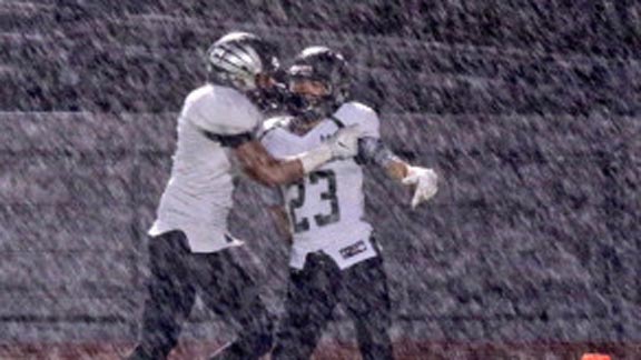 Isaac Drake of Eureka St. Bernard's celebrates after scoring TD during heavy rainstorm in CIF Division VI-AA bowl game held in Laguna Hills. Photo: Patrick Takkinen/OCSidelines.com.