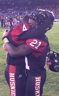 Player of the game J.J.Taylor (21) gets a hug from teammate Miles Reed. Photo: Mark Tennis.