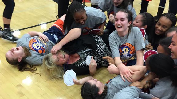 Chaminade head coach Kelli DiMuro wasn't shy about rolling on the floor as part of dog pile after team won second straight CIFSS Open Division title. Photo: Harold Abend.