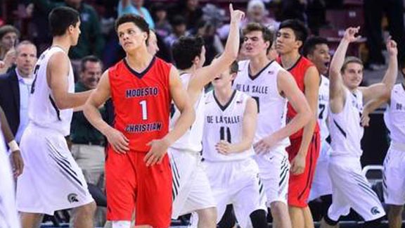 Modesto Christian's Christian Ellis walks toward bench amid De La Salle players celebrating after CIF NorCal final. Photo: John Westberg/The Modesto Bee.