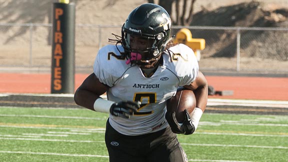 Big-time running back Najee Harris turns corner for Antioch in high-scoring win over arch-rival Pittsburg. Photo: SportStarsOnline.com.