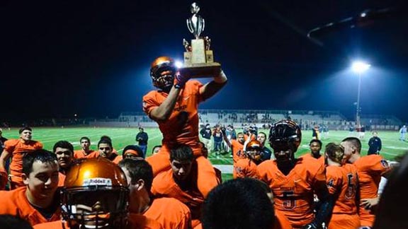 Merced running back Jabar Byrd hoists Bernasconi Memorial Mayor's Cup after win vs. city rival Golden Valley during 2014 season. Photo: Andrew Kuhn/MercedSunStar.com.