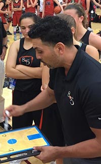 George Albanez goes over plays with girls from 805 Basketball during Summer in the City club tourney. They traveled further than most but it seemed to pay off. Photo: Harold Abend.