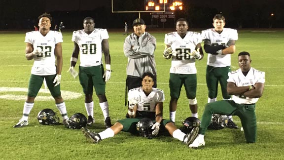 Players and head coach Manuel Douglas of No. 7 Narbonne give their best "no smile' pose after their big win Friday over Serra of Gardena. Photo: @CIFLACS/Twitter.com.