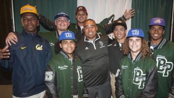 Buena Park head coach Anthony White stands with players from last year's team who playing in college, including those at Cal, Utah and Univ. of New Mexico. Photo: hometeamsonline.com.