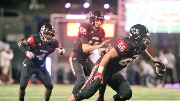 Centennial QB Tannier McKee gets ready to take snap with RB Miles Reed at his side and OL Solo Vaipulu looking for someone to block during last Saturday's game vs. IMG of Florida at Mission Viejo. Photo: Patrick Takkinen/SoCalSidelines.com.