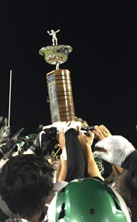 Holy Bowl trophy gets hoisted by St. Mary's players after it was given to them by a coach from Central Catholic (which won the game last year). Photo: Mark Tennis.