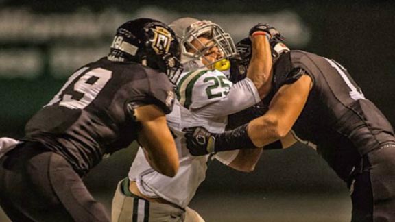 Defensive players from Servite of Anaheim make a stop on De La Salle's Kairee Robinson during the Friars' near-upset of the Spartans last Friday. Photo: Terry Jack/SoCalSidelines.com.