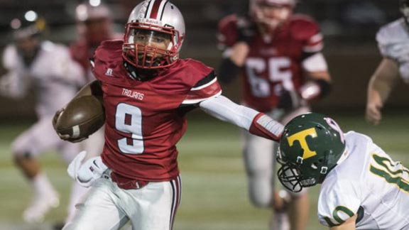 Lincoln of Stockton QB Aaron Thomas gives a stiff-arm during game last season. He had 396 yards passing in game last week. Photo: RecordNet.com. 