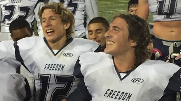 Freedom QB Jonathan Pierce and TE/DE Jason Ternes listen to their coaches after their team came from behind to beat Pittsburg 41-38 in NorCal Game of the Week. Photo: Mark Tennis.