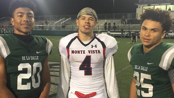 There is always a lot of mutual respect when De La Salle plays Monte Vista. Reciever Isaiah Randle of Monte Vista also used to play at De La Salle. He's shown with senior DB Tre White (20) and junior RB Kairee Robinson (25). Photo: Mark Tennis.