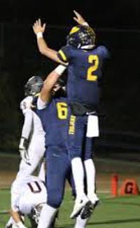 Oak Ridge QB Marco Baldacchino got a lift from a teammate after TD late in the season. Photo: Twitter.com.