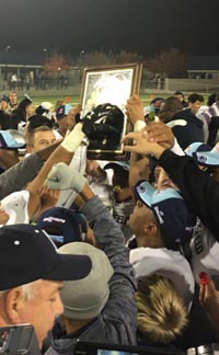 Bakersfield fans and players gather around CIF Central Section Division I title plaque after win Friday in Fresno. Photo: @BVarsityLive/Twitter.com.