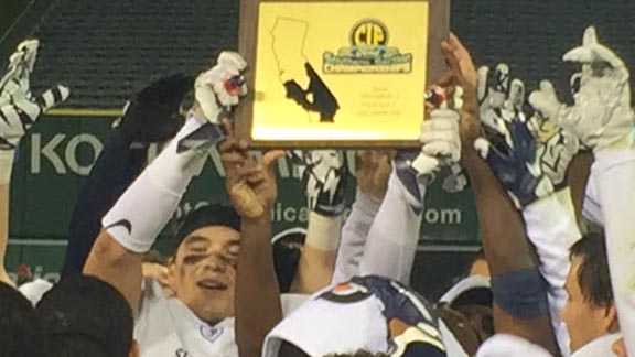 Players from St. John Bosco fight to get their hands on the CIF Southern Section Division I championship plaque after win Saturday at Angels Stadium. Photo: Mark Tennis.
