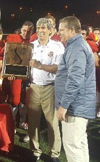 Cathedral Catholic head coach Sean Doyle collects CIF SoCal title plaque after team topped Narbonne on Friday. Gauchos were trying to win D1-AA state title after winning it in D1-A last season. Photo: SoCalSidelines.com.