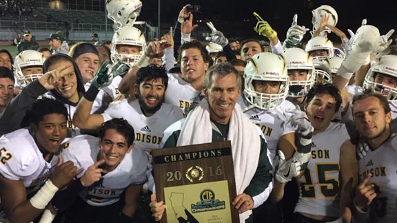 Edison of Huntington Beach head coach Dave White (who is retiring after the season) holds CIF Southern Section Division III title plaque after No. 16 Chargers beat No. 15 La Mirada 44-24 on Friday night at La Mirada. Photo: Mark Tennis.