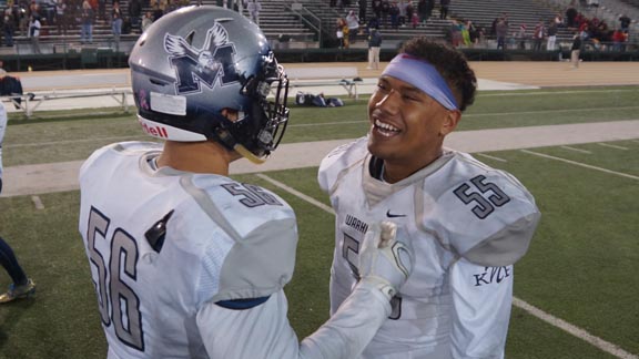 San Diego Madison teammates Chris Fatilua & Sampson Niu greet each other just after team won CIF Division 2-AA state championship. Photo: Phillip Walton/SportStars.