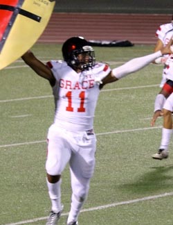 Grace Brethren's Noah Bean has some fun with school's shield prop. Photo: Grace Brethren football.