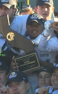 Players from Sierra Canyon gather around CIF D2-A title game trophy after win over San Mateo Serra. Photo: Mark Tennis.