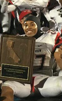 Valley View of Moreno Valley player poses with title plaque after team topped San Gorgonio. Photo: SoCalSidelines.com.